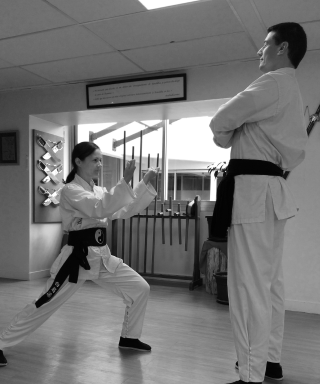 Femme maîtrisant une technique de Kung-Fu face à un homme